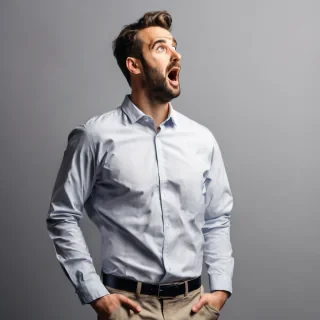 a man standing waist up wearing a office shirt looking amazed